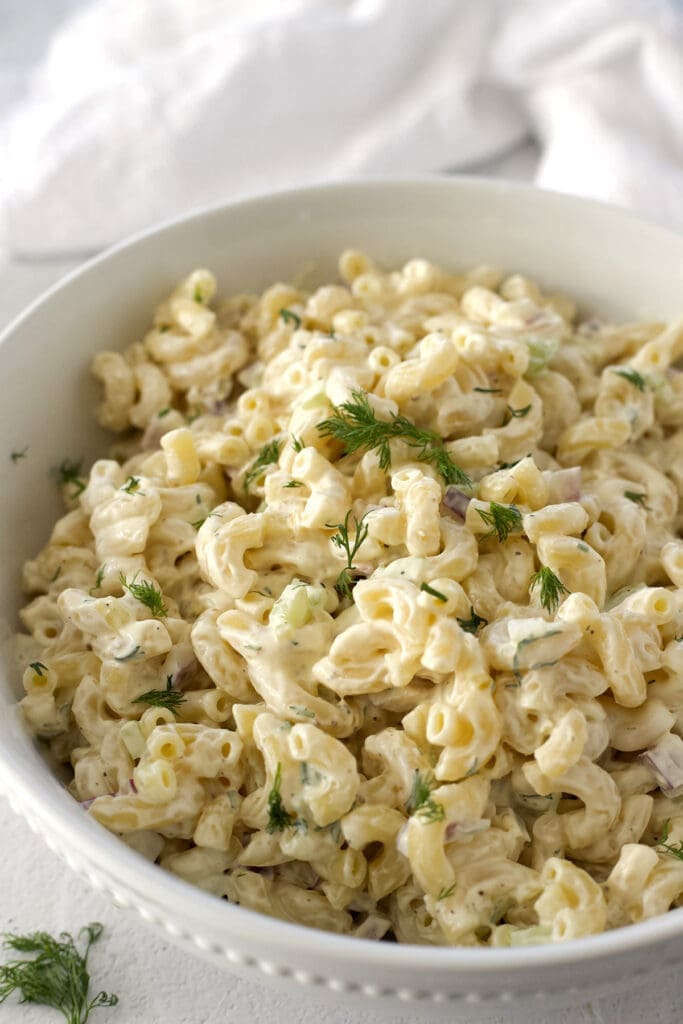 Classic pasta salad in a white bowl.