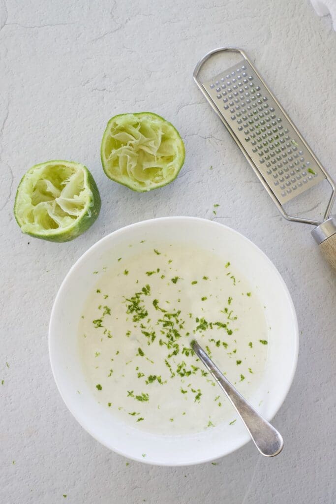 Tangy taco sauce in a small bowl with a spoon. 