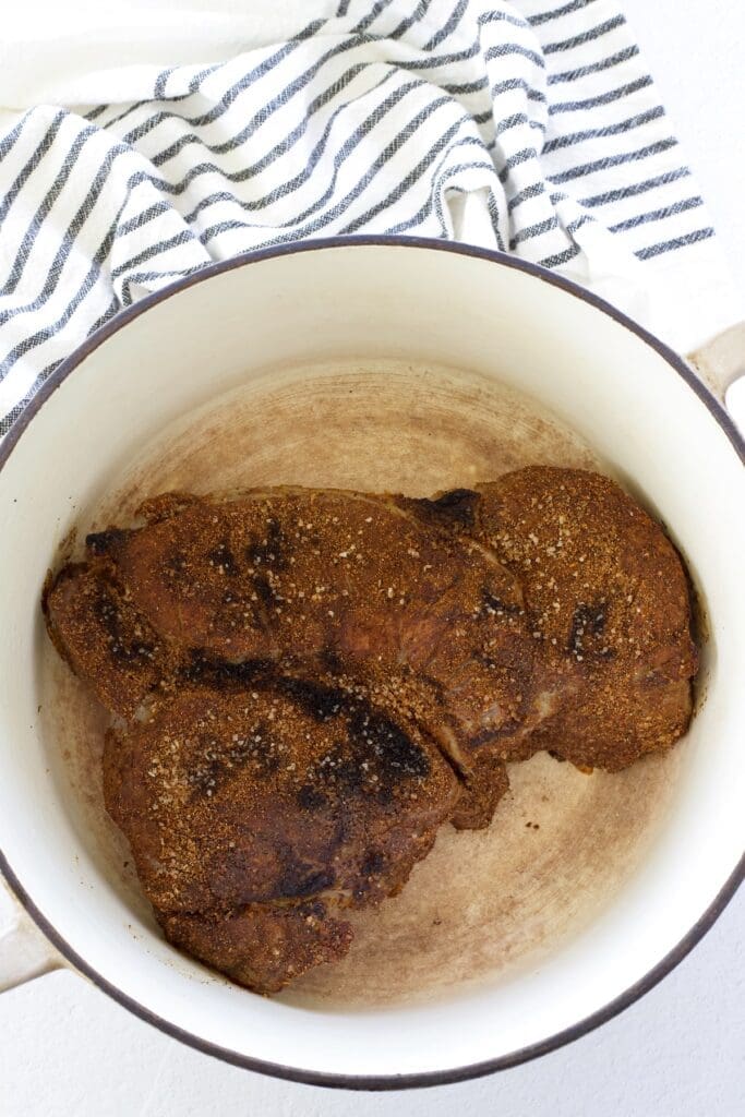 Seared beef in a dutch oven.