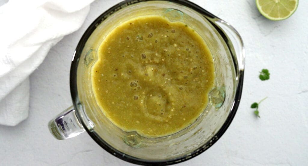 Green salsa in a blender.