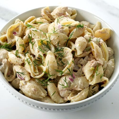 Bowl of tuna pasta salad with fresh dill.