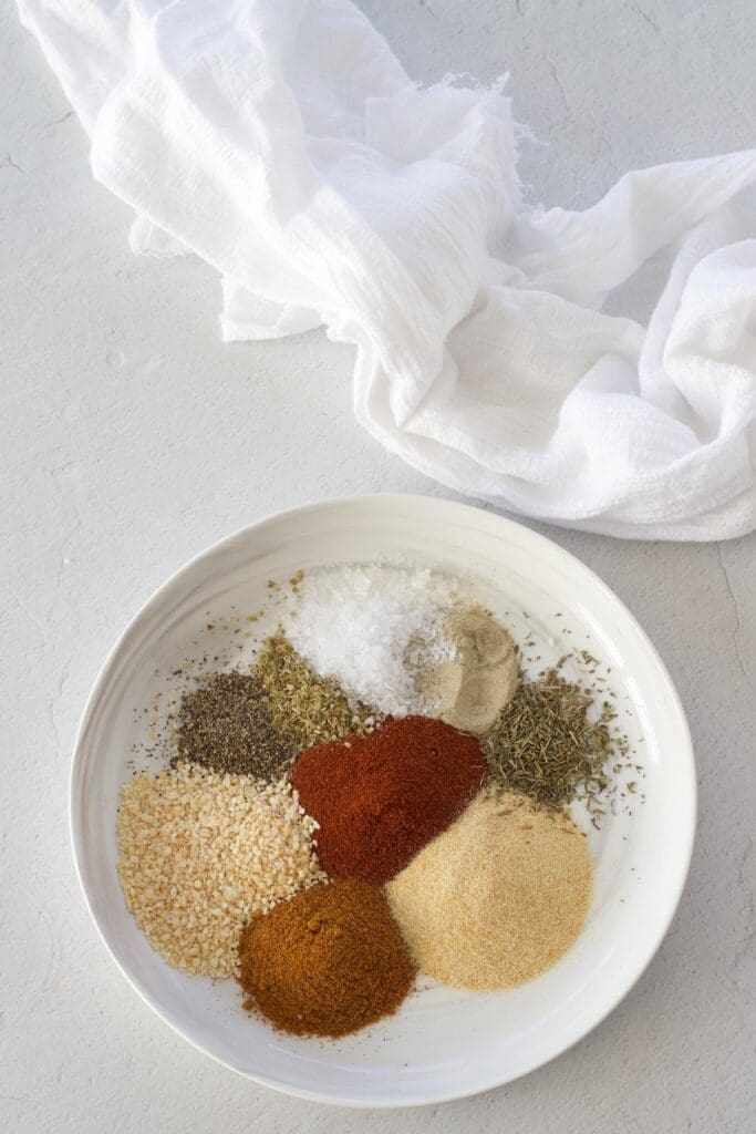 A white plate full of spices for making blackhead seasoning.