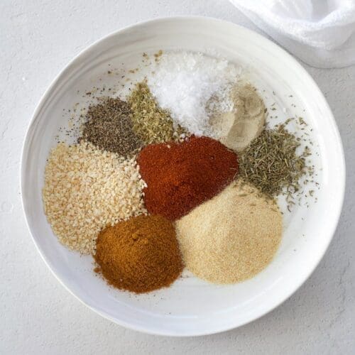 A white plate full of spices for making blackhead seasoning.