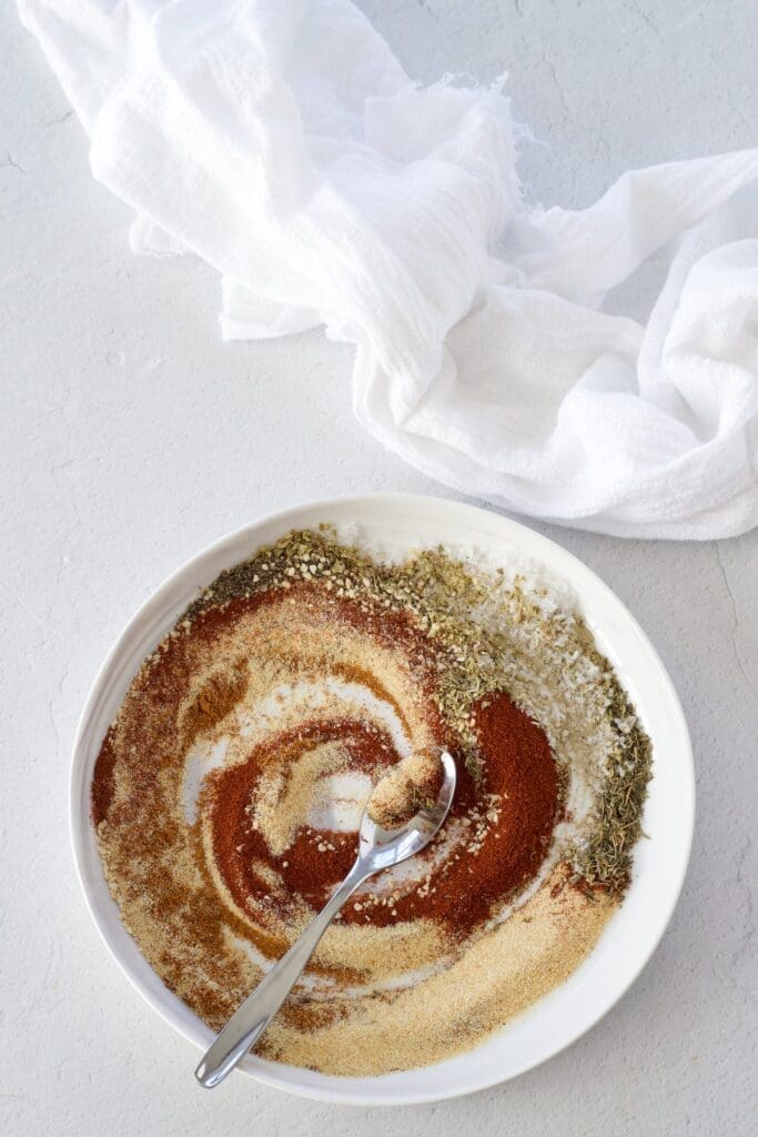 A white plate full of spices for making blackhead seasoning.
