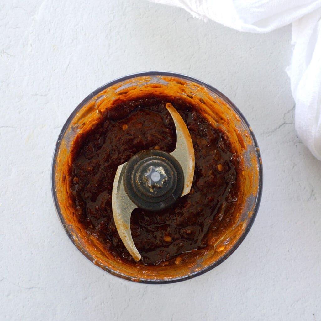 Blender filled with red sauce.