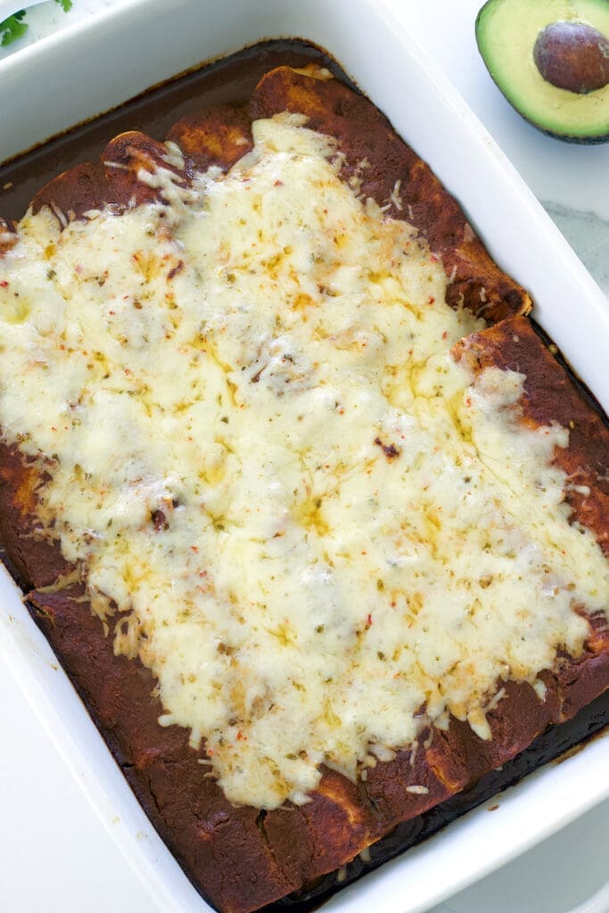 baked beef enchiladas topped with shredded cheese.