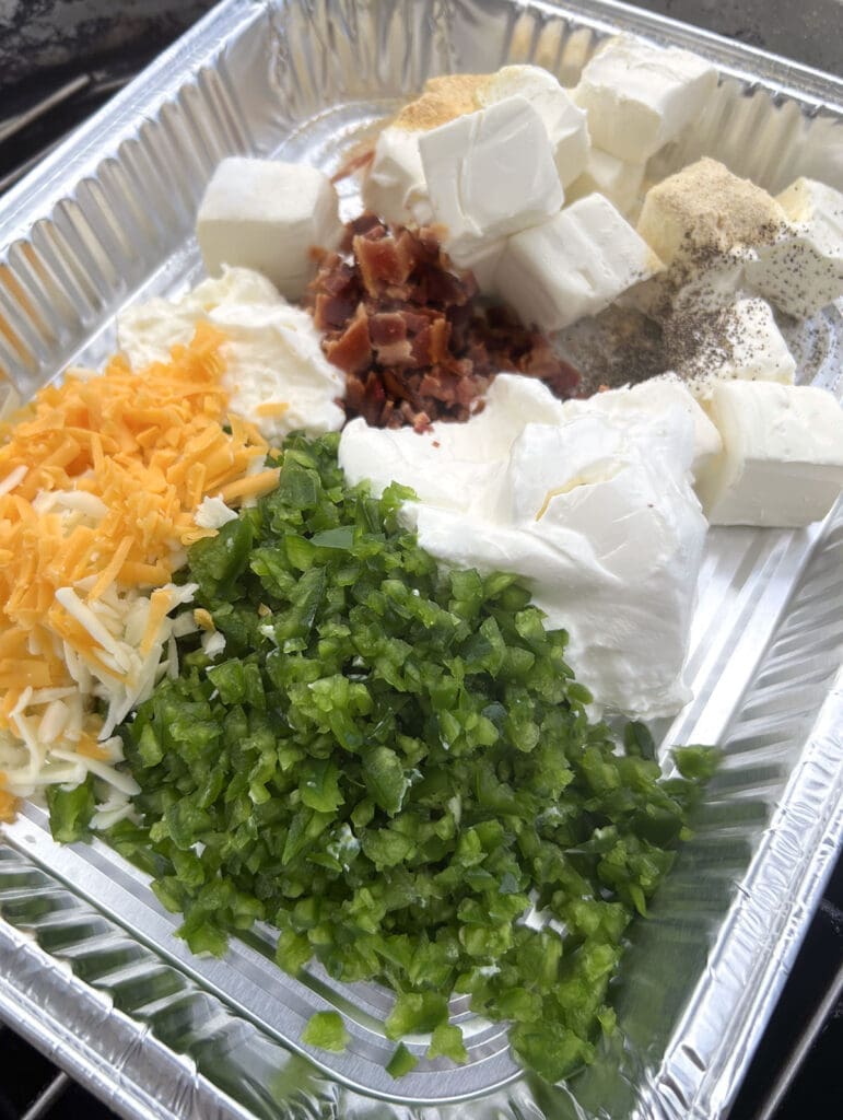 Variety of vegetables and cheese in an aluminum pan.