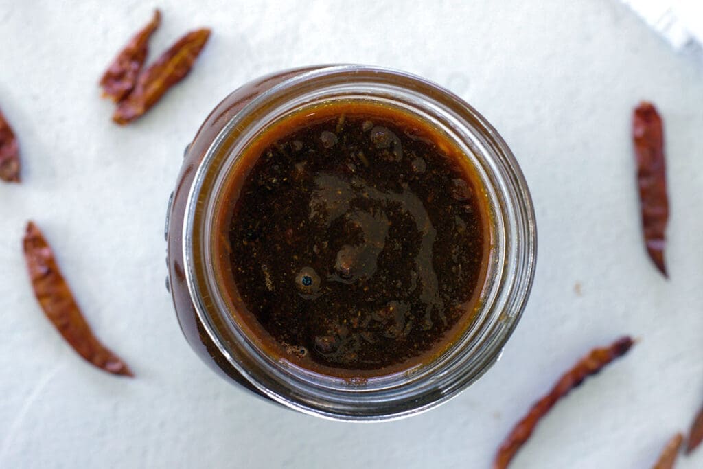 Red enchilada sauce in a clear container.